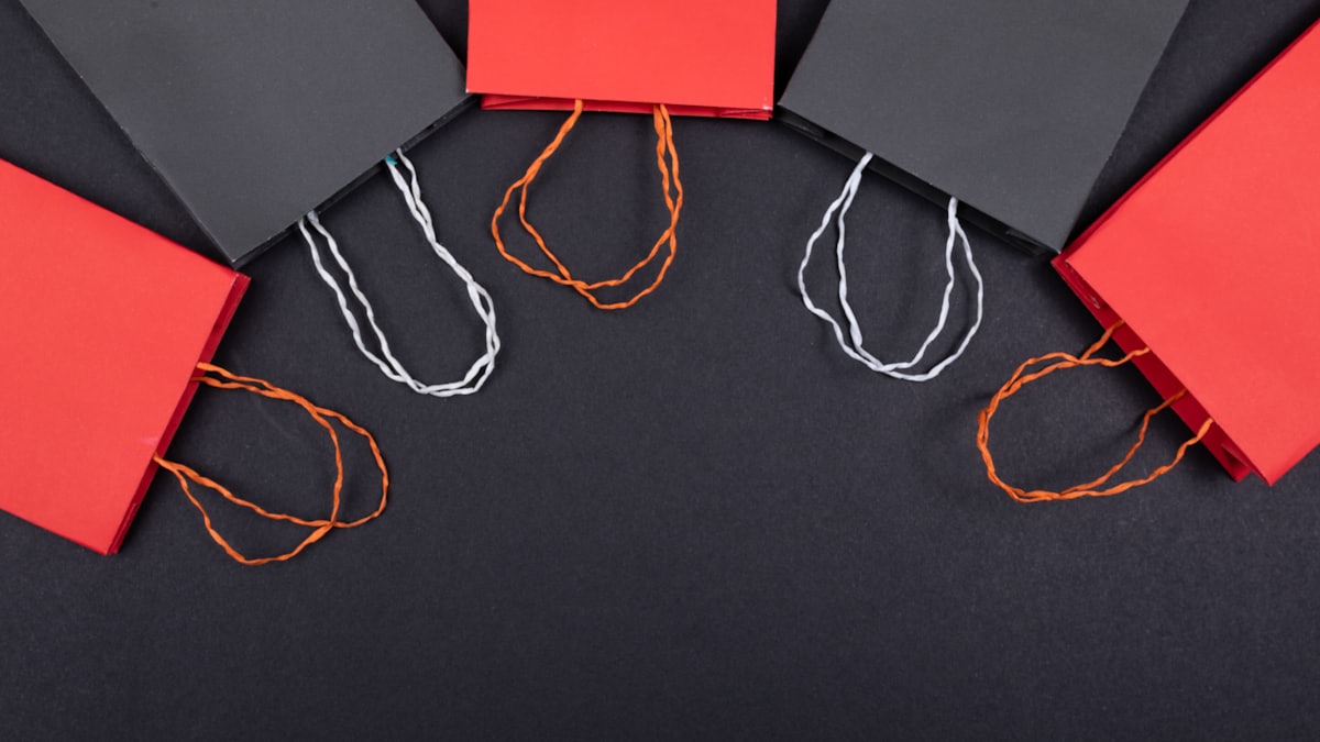 Retail shopping bags arranged on a dark surface